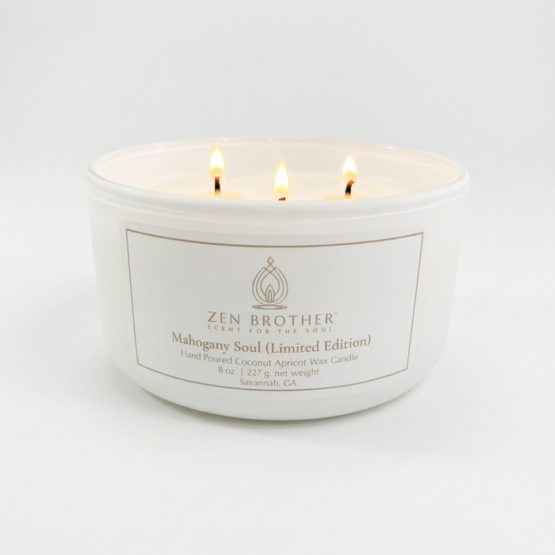 Image of a lit 3-wick candle