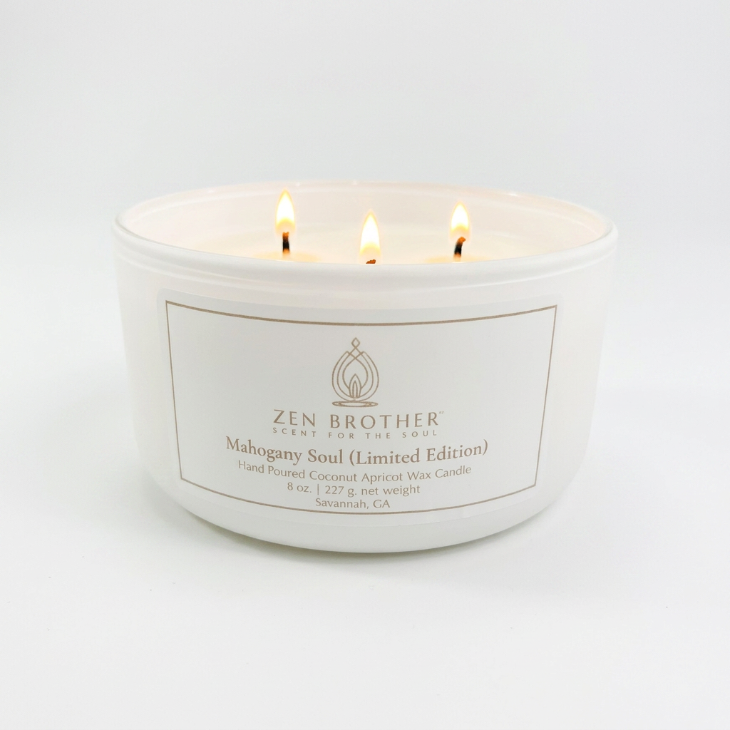 Image of a lit 3-wick candle